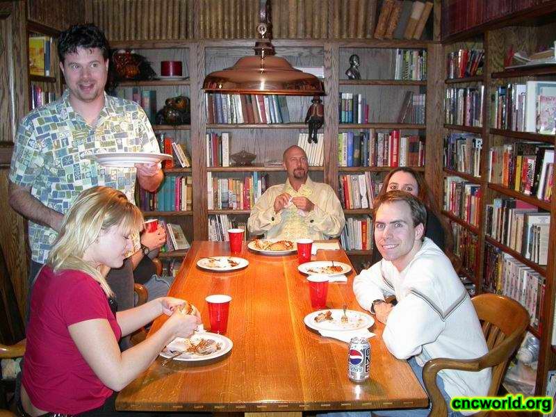 Joe Kucan and others dine in the library (at his house).
